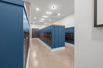 A long hallway with blue walls and a white ceiling.
